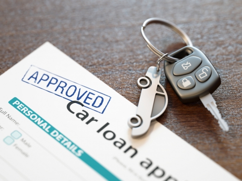 Approved car loan application with car keys